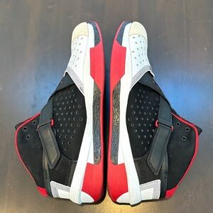 Black and Red High-Top athletic Jordan’s size 13.5